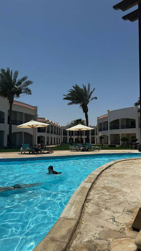 A resort with a swimming pool and lounging area.