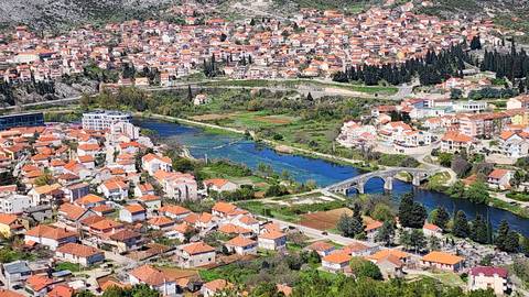       Scenic aerial view of a city with rivers and bridges.
  