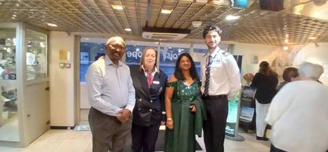 Group of people posing inside a building.