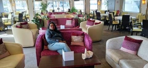 Person sitting in a modern lounge area.