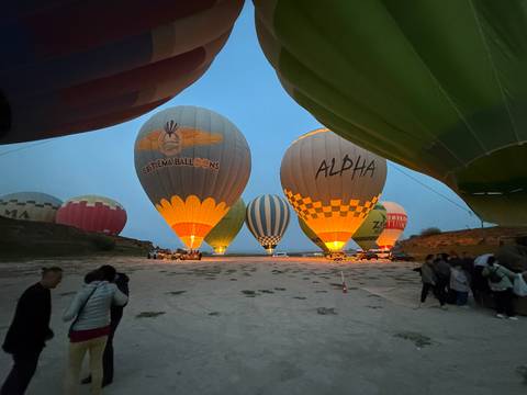 Hot air balloons prepared for liftoff early in the morning.