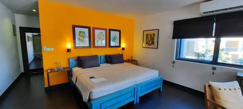       Colorful bedroom interior with a large bed.
  