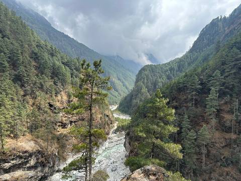 Lush green valley with a river running through it.
