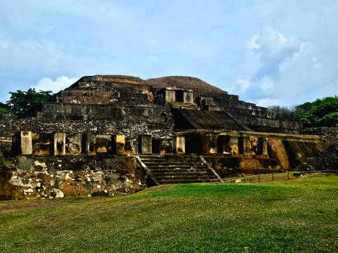 Large stone temple with steps and columns.