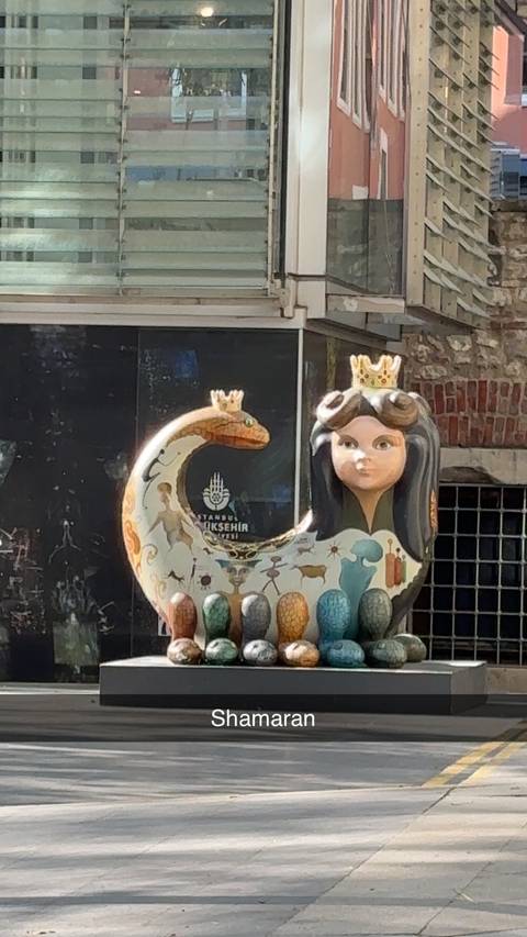 Decorative sculpture of a mythological figure with a crown.