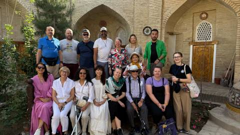 Group of people standing in front of a traditional building.