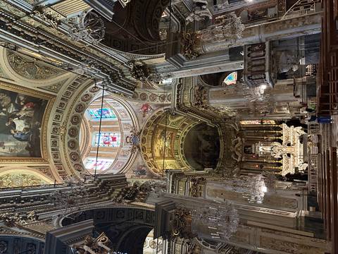       Ornate interior of a historical building with intricate details and stained glass windows.
  
