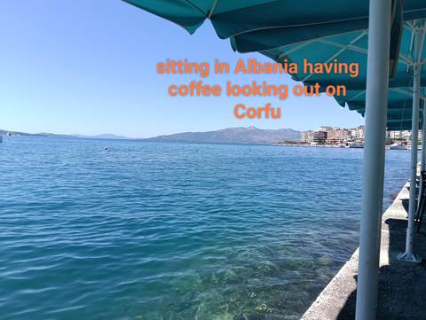 View of the sea with overlay text about coffee and Corfu.