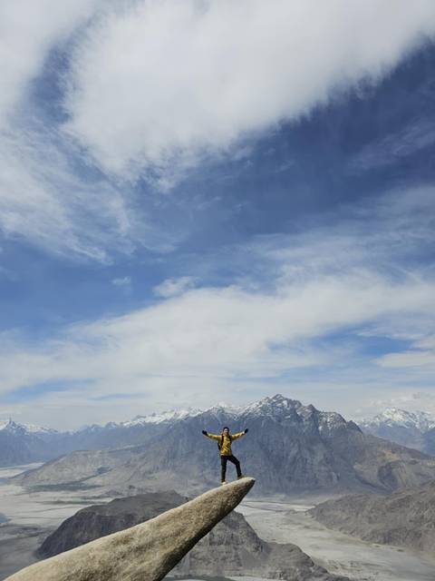       Vast open sky with distant mountain peaks.
  