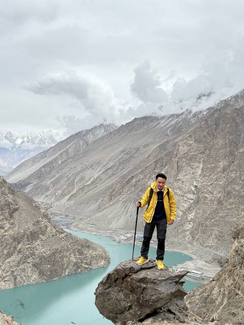      Person hiking with mountains in the background.
  