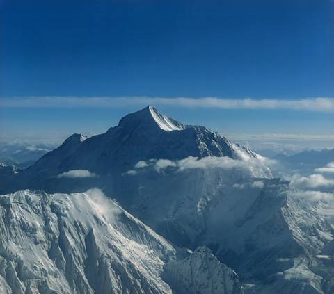 Majestic snow-covered mountain peak under a clear sky.