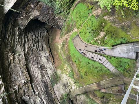 Overhead view of a large cave entrance with walkway.