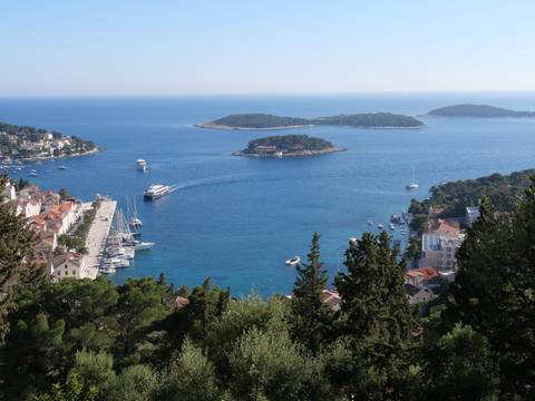 Scenic view of Hvar Island with a port and blue waters.