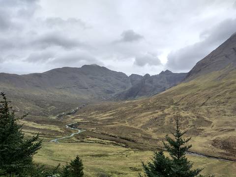       Mountainous terrain with a river flowing through the valley.
  