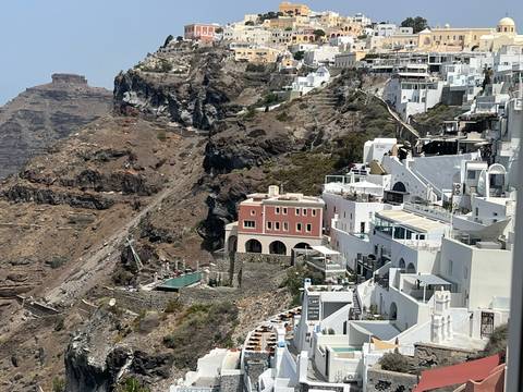 Cliffside view of buildings with white facades.