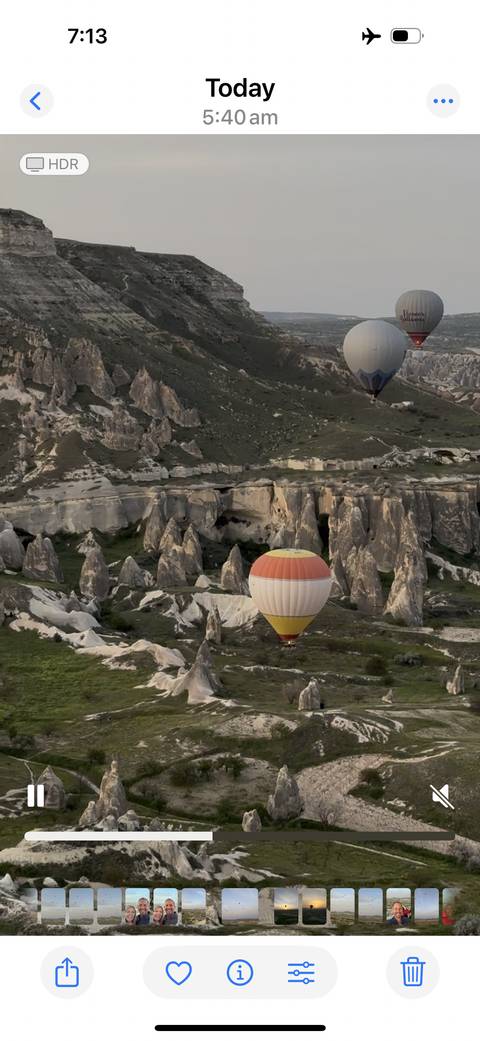       Hot air balloon floating over unique rock formations.
  