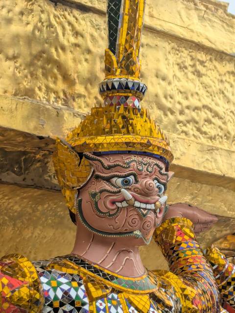 Close-up of a statue with a golden headdress.
