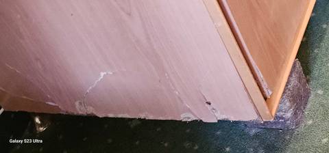 Damaged wooden furniture with a watermark of a model name 'S23 Ultra'.