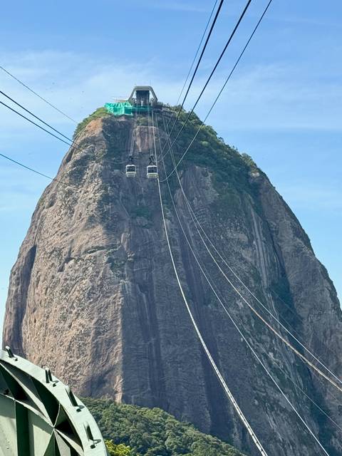      Cable cars ascending a steep mountain peak.
  