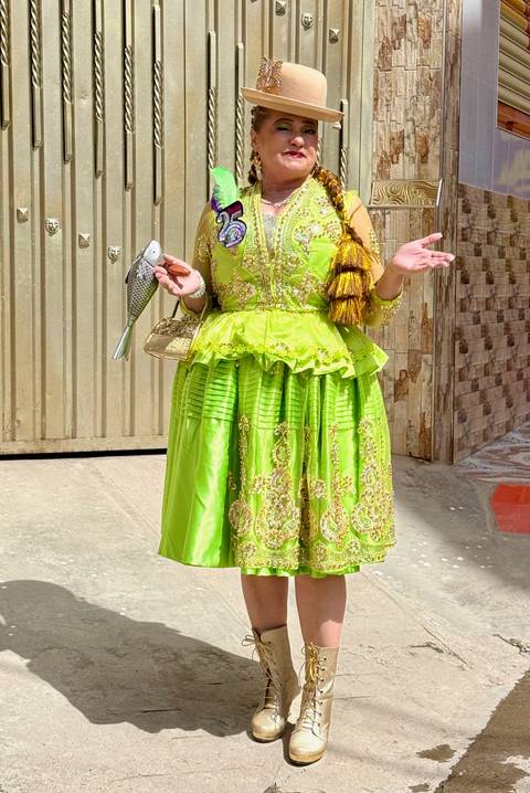       A woman in a bright green traditional dress.
  