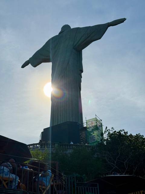 Christ the Redeemer statue with a sun halo.