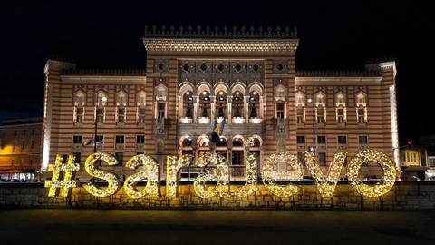       Lit-up Sarajevo city hall with decorative lights.
  