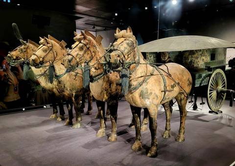       Terracotta horses and chariot on display.
  