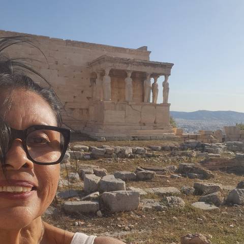       Person in front of ancient architectural ruins.
  