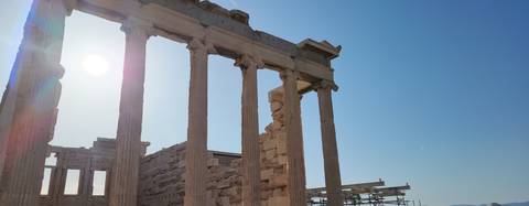       Ancient ruins with columns under the sunlight.
  