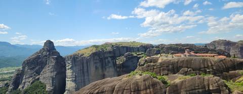       Dramatic rock formations with a monastery.
  