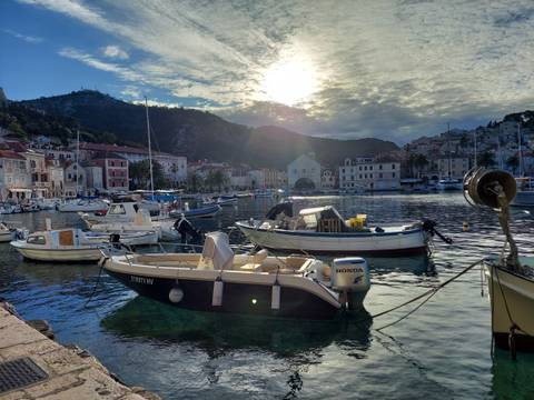 Harbor with boats at Hvar Island with mountainscape.