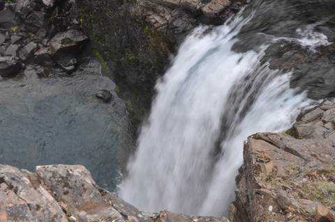 Waterfall cascading into a rocky pool.