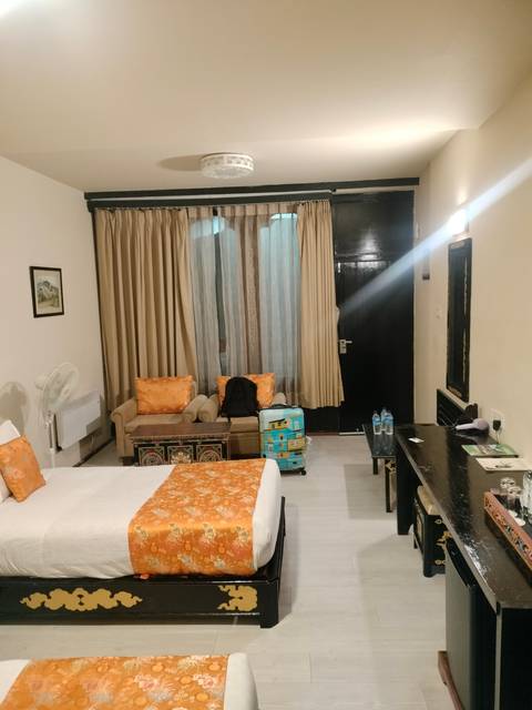       Interior of a hotel room with bed and luggage.
  