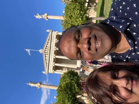 Couple with a Greek building in the background.