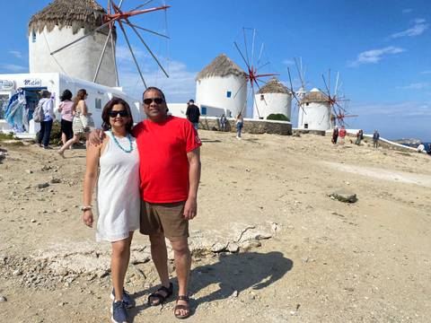 Couple with traditional windmills in the background.