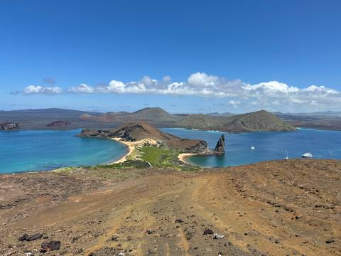 Panoramic view of islands with bright blue water and rocky shores.