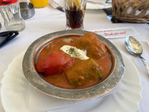 Traditional dish of stuffed peppers on a plate with a napkin beside.