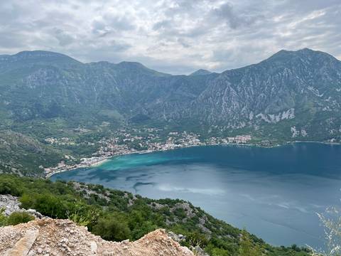 View of a bay with mountains surrounding clear blue water.