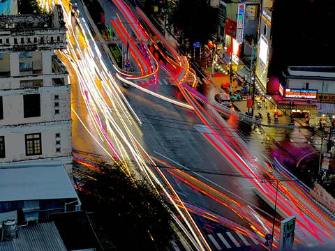 Long exposure of traffic lights on a rainy street at night.