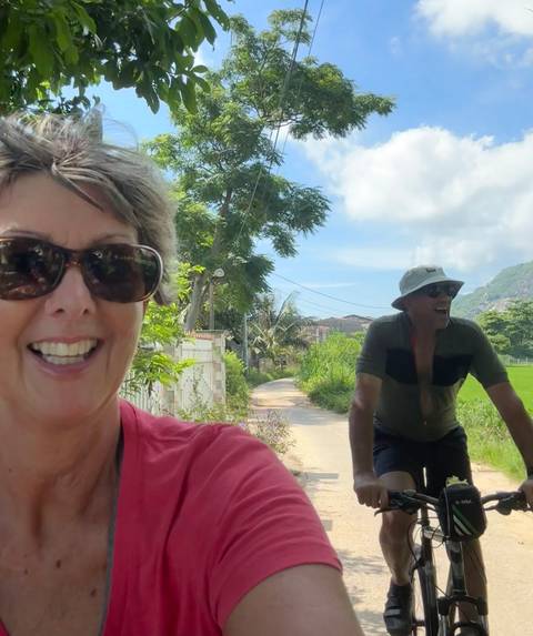       Close-up of cyclists smiling and enjoying the road.
  