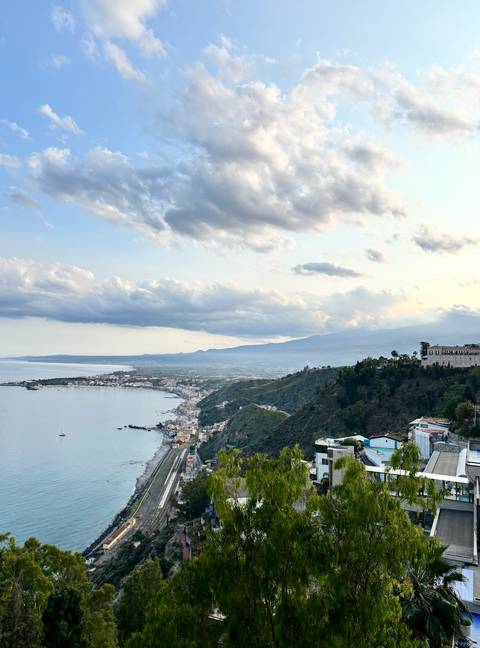 Coastal view with hills and a town in the distance.