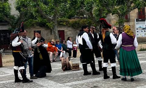 People dressed in traditional attire performing in a public space.