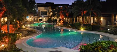       Illuminated outdoor swimming pool at night.
  