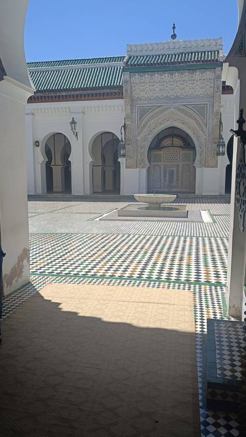       A tiled courtyard with a central fountain.
  