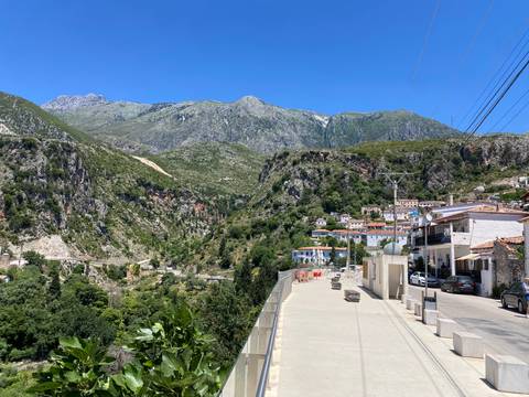       A village with mountains in the background.
  
