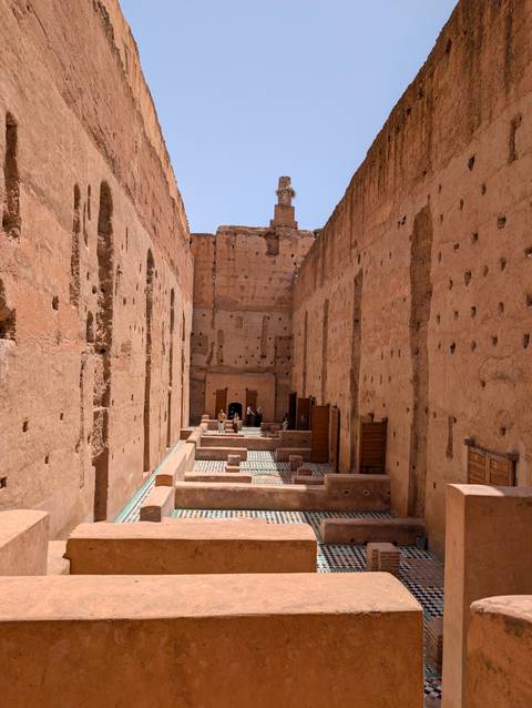       Ancient ruins with decorative tiles on the floor.
  