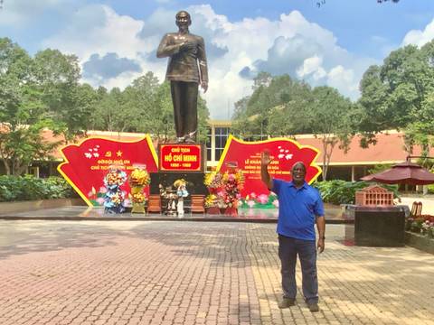       Person holding a bunch of bananas on a boat.
  