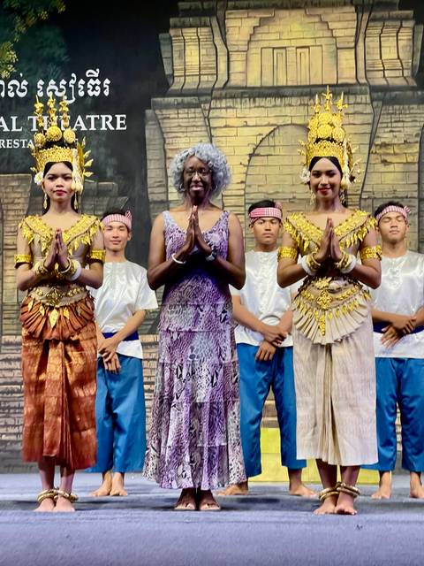 People enjoying a cooking activity on a boat with scenic views.