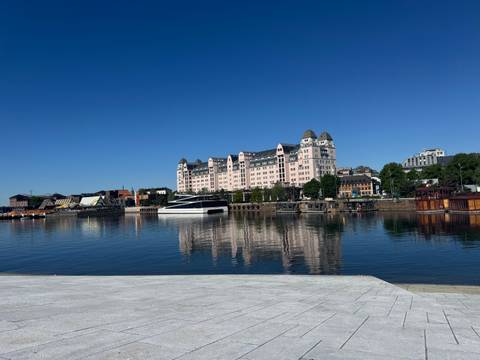 Waterfront view with buildings and reflections on a clear day.