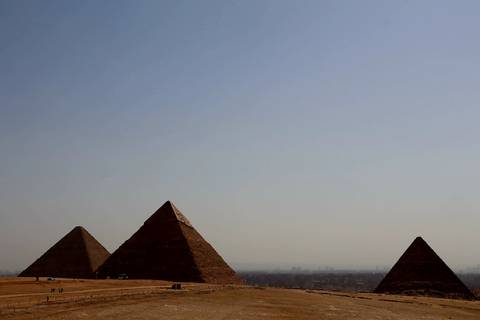       Three pyramids under a clear sky.
  